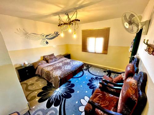 a bedroom with a bed and a bird on the wall at Petra Pottery Hostel in Wadi Musa