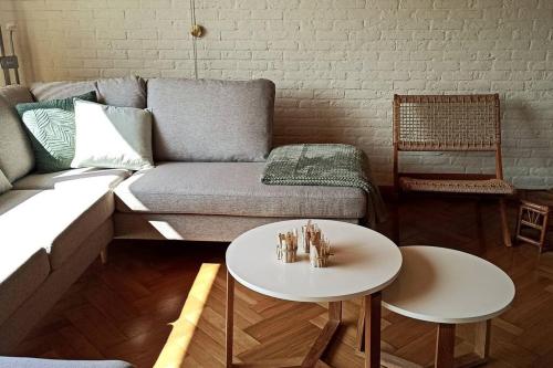 a living room with a couch and a table at Mozaïkhuis in De Haan
