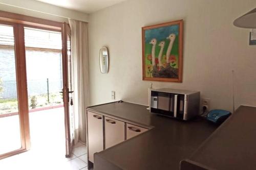 a kitchen with a microwave on top of a counter at Mozaïkhuis in De Haan