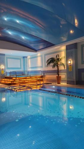 a large swimming pool in a hotel room at Wyndham Grand Izmir Ozdilek Thermal & Spa in Izmir