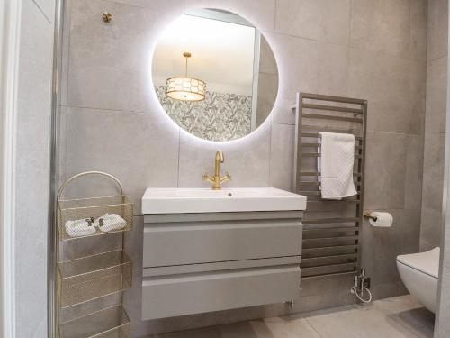 a bathroom with a sink and a mirror at Castleys in Skipton