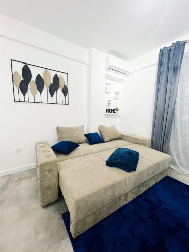 a bedroom with a large bed and a couch at SEASALT Apartments Rafailovichi in Budva