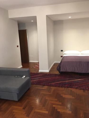 a bedroom with a bed and a couch in it at MH Design Hotel in Naples