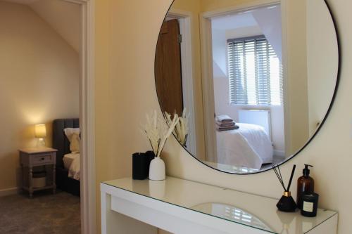 a mirror on a counter in a room with a bed at No 1 The Paddock - Spacious holiday home with a hot tub in Bude