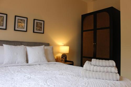 a bedroom with a bed with white pillows and a lamp at No 1 The Paddock - Spacious holiday home with a hot tub in Bude