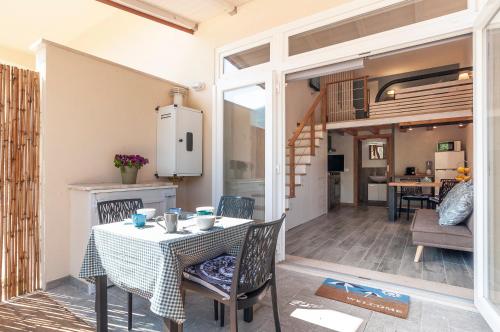 a kitchen and dining room with a table and chairs at Circeo Holiday Houses in San Felice Circeo