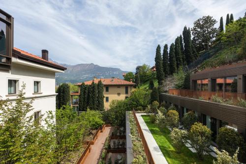 a view of a garden from a building at Hotel Promessi Sposi in Malgrate