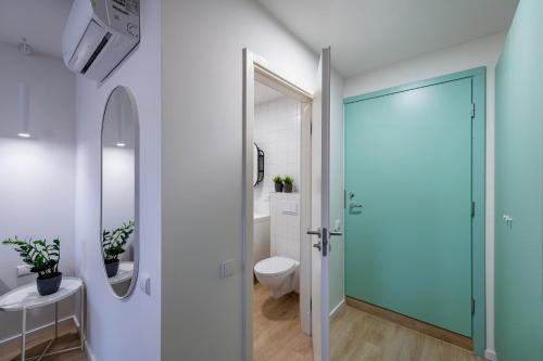 a bathroom with a toilet and a glass door at UAB Laisvės alėjos viešbutis in Kaunas
