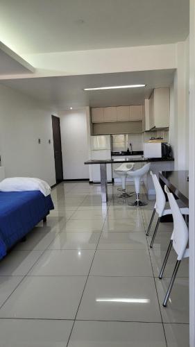 a large room with a bed and a kitchen at Guemes Apartment in San Juan
