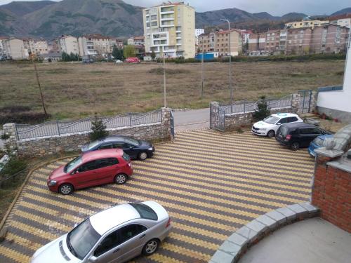 a group of cars parked in a parking lot at Hotel Roberto in Korçë