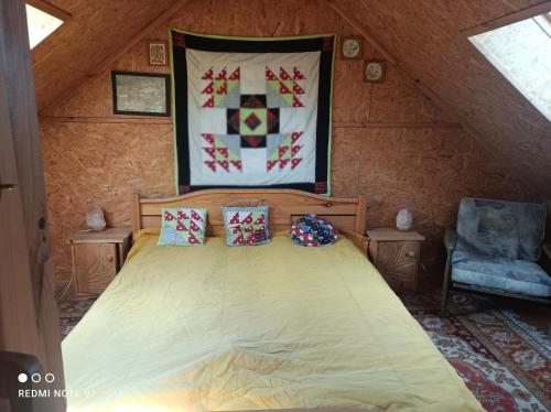 a bedroom with a large bed in a attic at Miód -Malina 