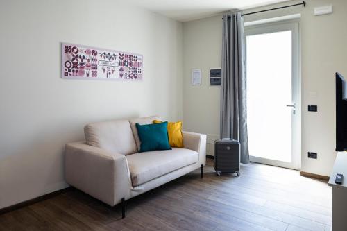 a living room with a couch and a television at CASCINA SANT'ANTONIO in Alba