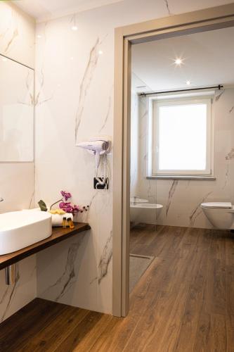 a bathroom with a sink and a toilet at CASCINA SANT'ANTONIO in Alba