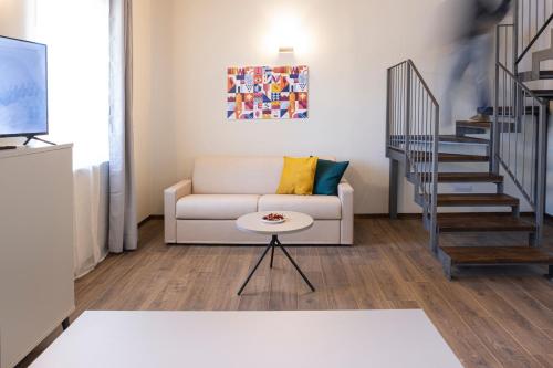 a living room with a couch and a table at CASCINA SANT'ANTONIO in Alba