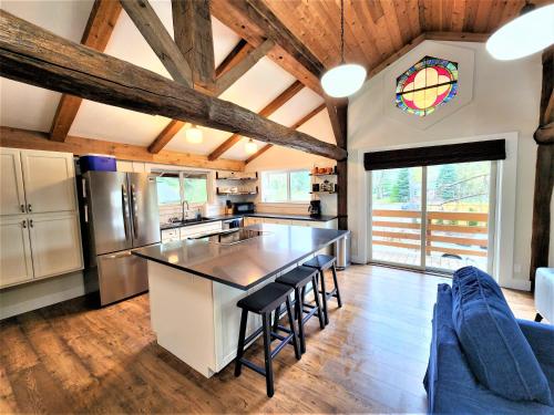 a kitchen with a table and chairs in a room at Beachside-HotTub-Fireplace-Authentically Northern in Traverse City