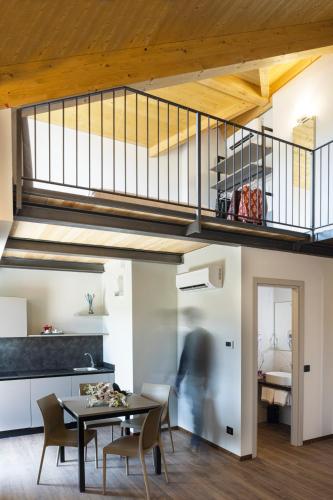 a kitchen and dining room with a table and chairs at CASCINA SANT'ANTONIO in Alba