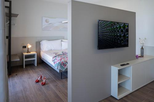a bedroom with a bed and a desk with red shoes at CASCINA SANT'ANTONIO in Alba