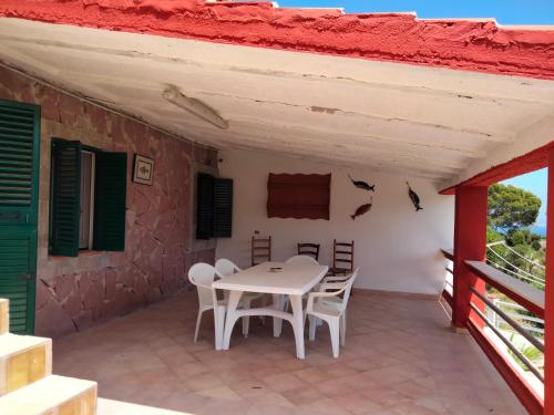 a table and chairs on the patio of a house at palma in Carloforte