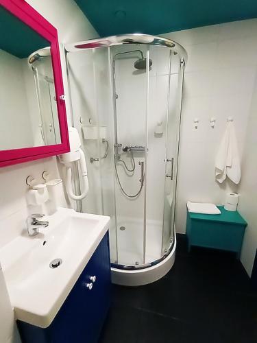 a bathroom with a shower and a sink at Good Times House in Katowice