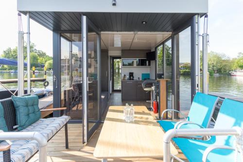 a boat deck with blue chairs and a table at Wohnboote Marina Niederhavel in Brandenburg an der Havel