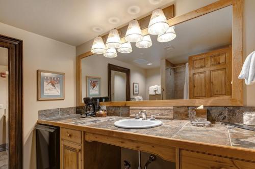 a bathroom with a sink and a mirror at The Lodges at Deer Valley AB in Park City