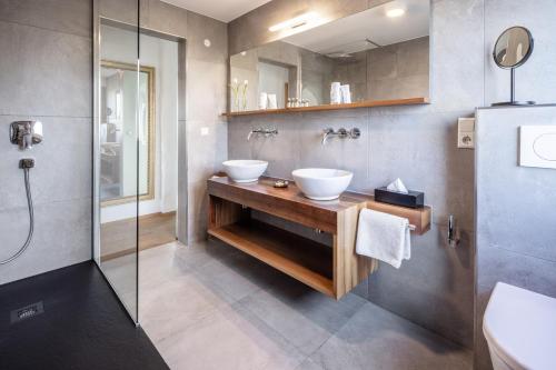 a bathroom with two sinks and a shower at Villa Neugarten in Hagnau