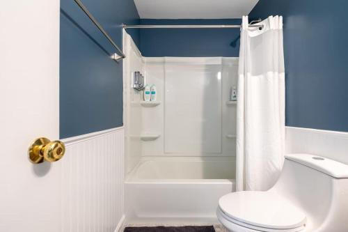 a bathroom with a white toilet and a shower at Relaxing 2-Master Suite Mountain Top - Fire Pit in New Market