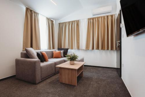a living room with a couch and a table at Bells Osijek in Osijek