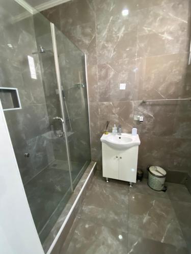 a bathroom with a shower and a sink at Jivil Shortlets in Lagos