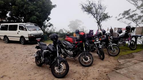 a group of motorcycles parked on a dirt road at Bel View Guest House in Haputale