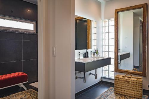 a bathroom with a sink and a mirror at Advania Country House in Lourinhã