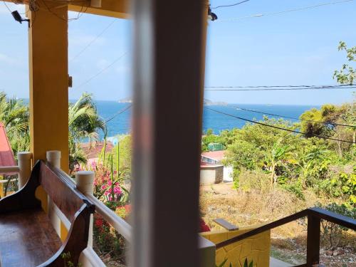 a view of the ocean from the balcony of a house at Cerrito Tropical Eco Lodge in Taboga