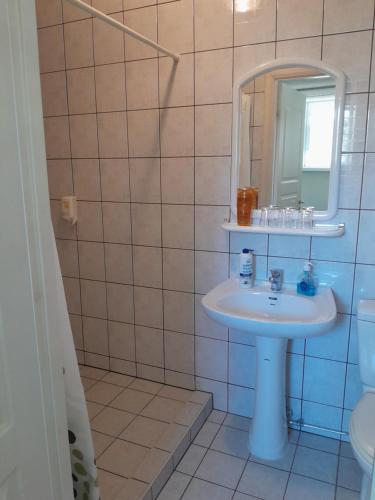 a bathroom with a sink and a mirror at Inge Villa in Pärnu