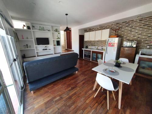 a kitchen and living room with a couch and a table at Loft5 a solo 2 cuadras de la Costanera!!! in Corrientes