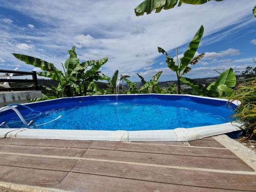 a large blue pool sitting on top of a deck at Quinta de S. Vicente 317 in Vila Nova de Famalicão