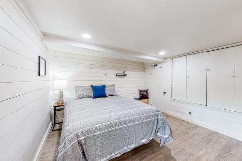 a bedroom with a bed with a blue pillow on it at Peck's Perch in Alder