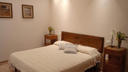 a bedroom with a bed with two night stands and two lamps at MAGNOLIA in Cortona