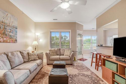 a living room with a couch and a tv at Creekwood - 400 Cascade Ln Unit# 418 in Rehoboth Beach
