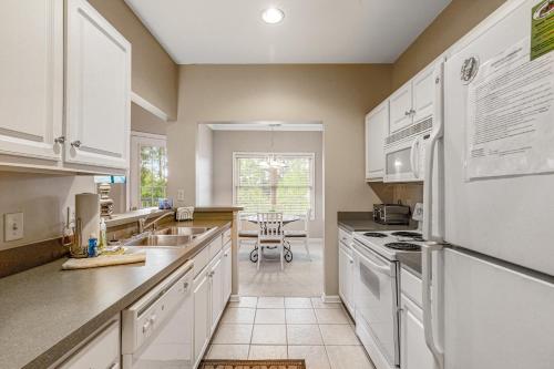 a kitchen with white appliances and a table at Creekwood - 400 Cascade Ln Unit# 418 in Rehoboth Beach