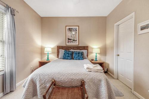 a bedroom with a large bed and two lamps at Creekwood - 400 Cascade Ln Unit# 418 in Rehoboth Beach