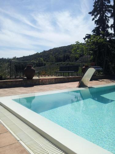 a swimming pool in a yard with at Hotel Pescille Country House - Tuscany Charme in San Gimignano