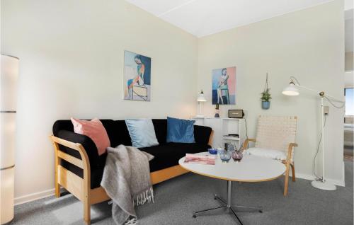 a living room with a couch and a table at Fanø Bad, Lejl 69 in Fanø