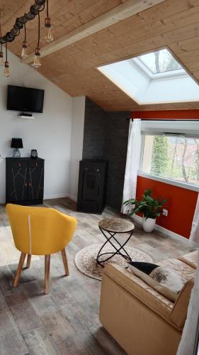 a living room with a couch and a window at Gîte des Roches in La Chaux-du-Dombief