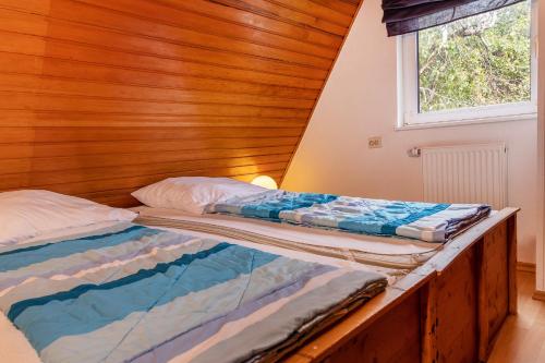 2 camas en una habitación con pared de madera en 50156..., en Harlesiel