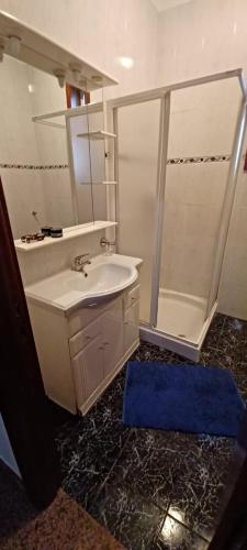 a bathroom with a sink and a shower at Quinta do Carvalho - Nature Guest Houses in Guimarães