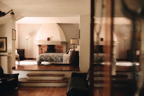 a bedroom with a bed and a fireplace at Le dimore de Il borgo del balsamico in Albinea