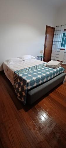 a bed sitting on top of a wooden floor at Quinta do Carvalho - Nature Guest Houses in Guimarães