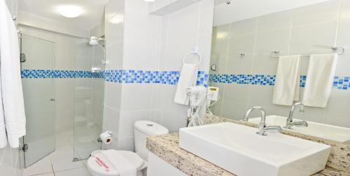 La salle de bains est pourvue d'un lavabo, de toilettes et d'une douche. dans l'établissement KING's FLAT HOTEL NATAL, à Natal