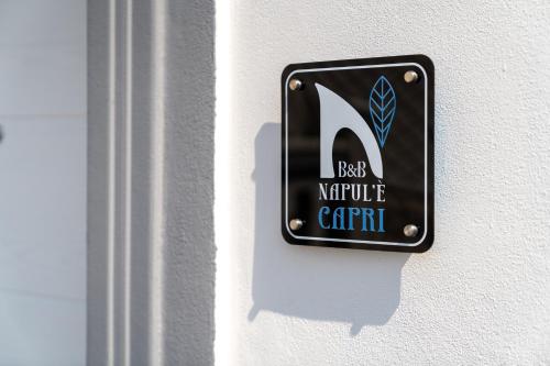 a sign on a wall that reads next knights particle court at Napul'è B&B in Boscotrecase
