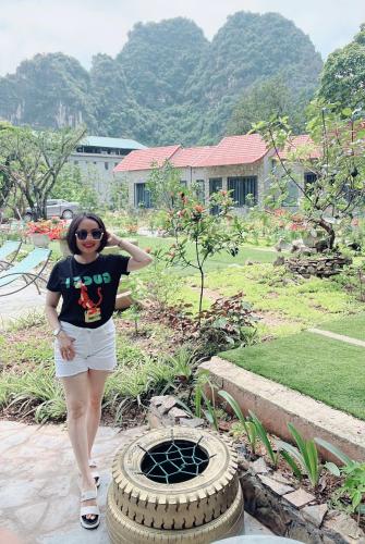 a woman standing next to a pile of tires at Trang an green river homestay in Ninh Binh